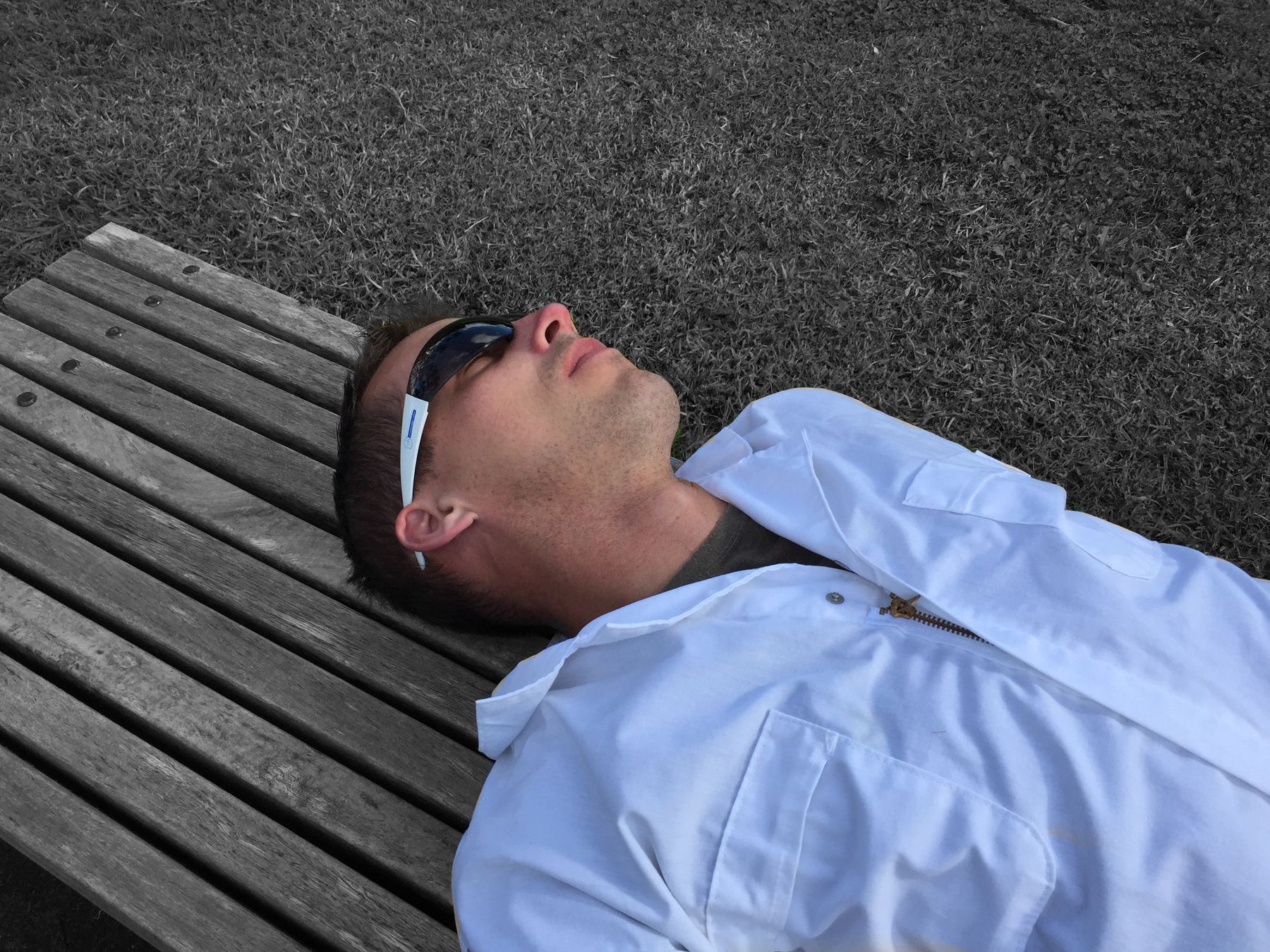 The Bogeyman, in the white overalls, flat on his back on a bench